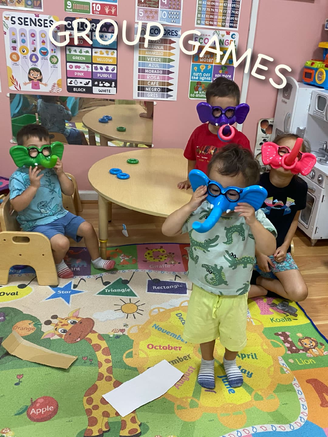 The kids are wearing elephant masks all in different colors. 