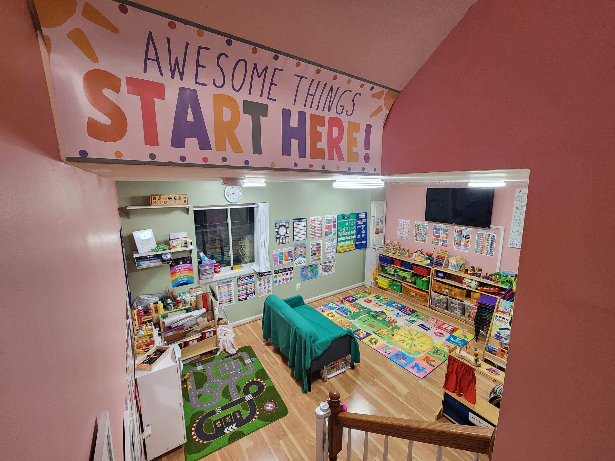 The 3 wall layout of the daycare showcasing its display of the toys, the sitting area, reaading wall, and art section. 